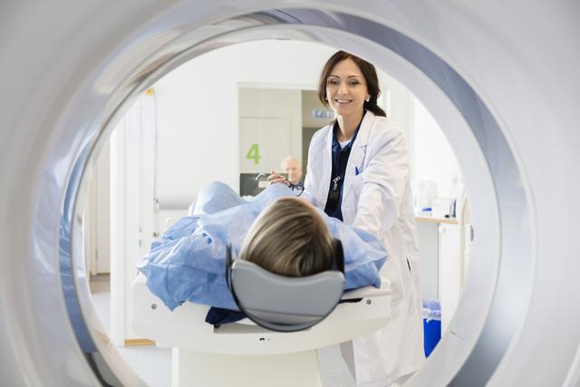 Radiation therapist treating patient