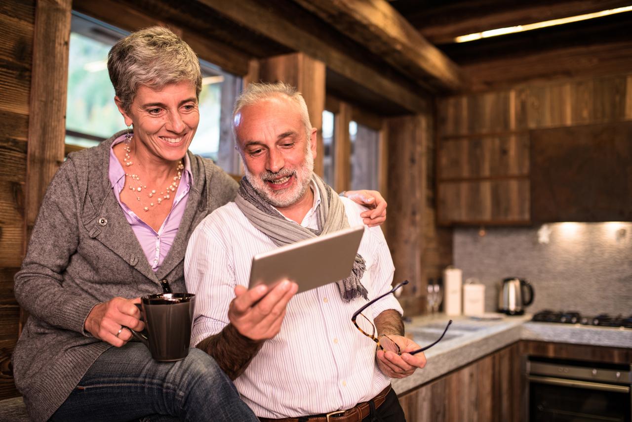 Man and woman enjoying time together looking over paperwork