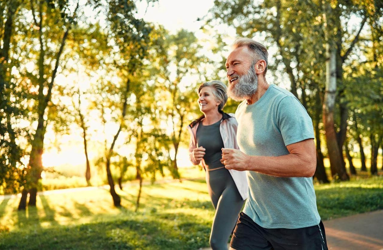 couple running in the park on a sunny day